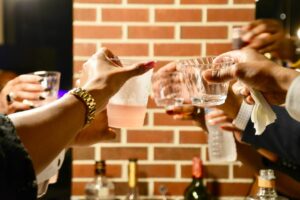 A group of people binge drinking. 