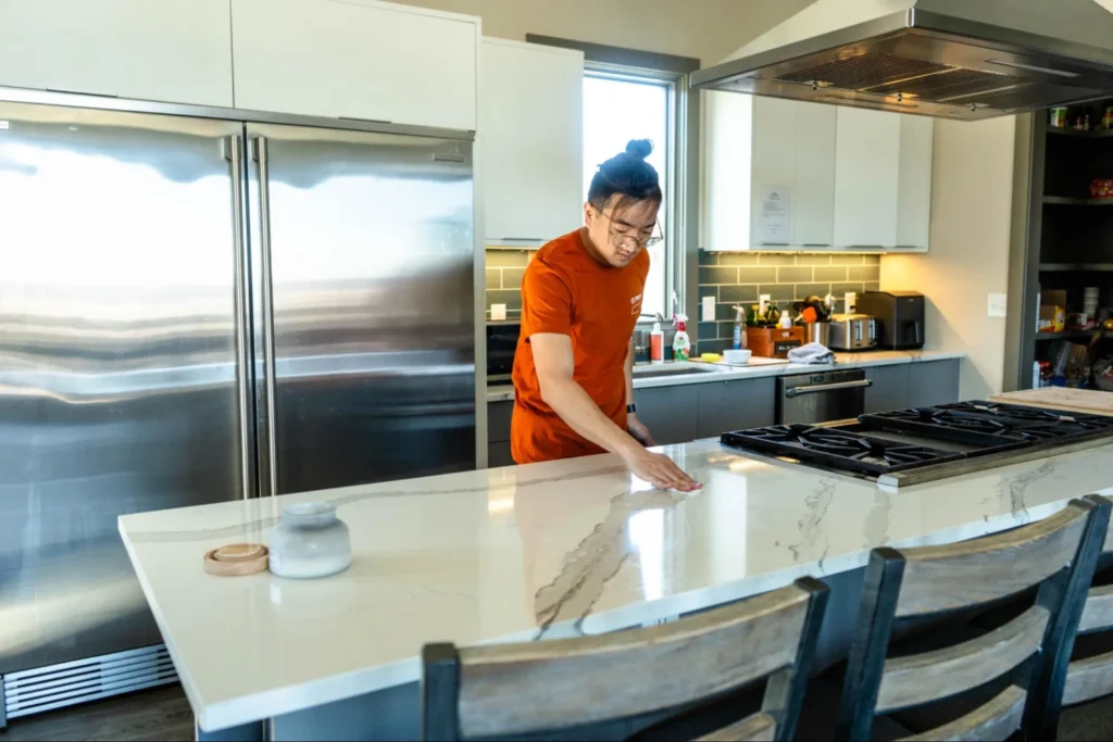 Resident maintaining shared kitchen space at a sober living home in Nashville.